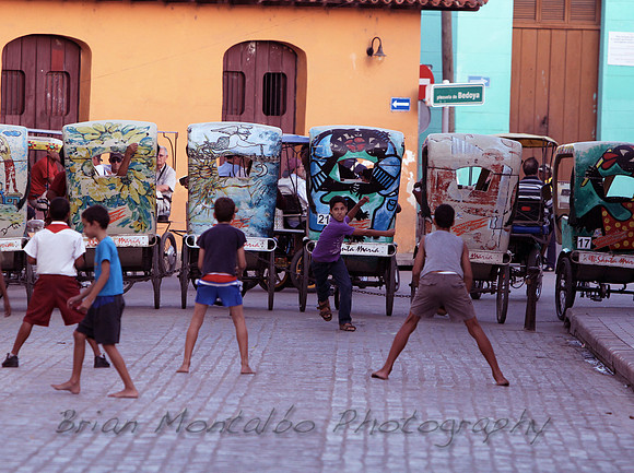 Kids playing baseball in streets of Cuba